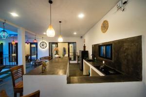 a living room with a kitchen and a dining room at YO Villa Canggu in Canggu