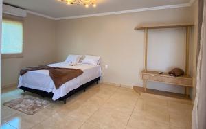 a bedroom with a bed with white sheets and pillows at Lusobra Flats Maragogi in Maragogi
