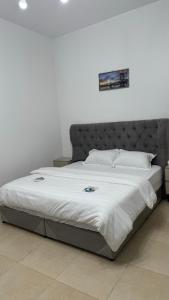 a bedroom with a large bed with a white comforter at استوديو عصري للإيجار in Riyadh