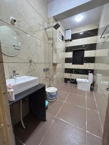 a bathroom with a sink and a toilet at MEENAKSHI GUEST Inn in Hampi +16 photos