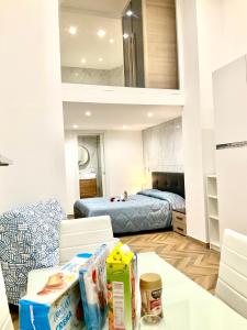 a room with a bed and a table with boxes on it at Gold suite19 in Catania +26 photos