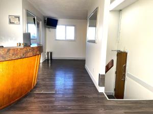 an empty hallway of an office with a counter at Sunset Inn in Esterhazy