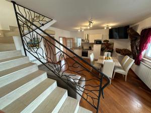 a spiral staircase in a living room with a dining room at Apartment Starčević in Kampor