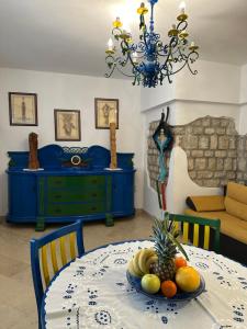 a dining room with a table with a bowl of fruit on it at Apartment Starčević in Kampor