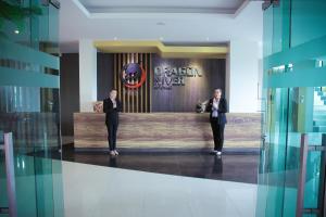 two men standing in front of a hotel lobby at Dragon River Avenue in Phitsanulok