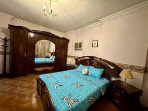 a bedroom with a bed and a large mirror at Luxury Lodge for Men in Cairo
