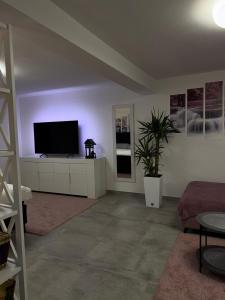 a living room with a flat screen tv on a white cabinet at Villa Maryann in Gornja Stubica