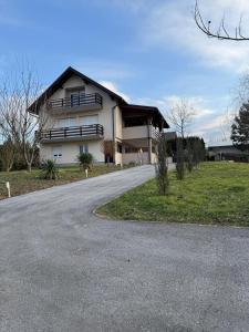 a large white house with a winding road at Villa Maryann in Gornja Stubica