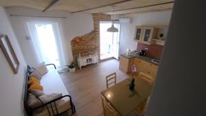 a kitchen and living room with a table and a couch at 65012 House in Cepagatti +15 photos