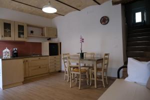 a kitchen and dining room with a table and chairs at 65012 House in Cepagatti