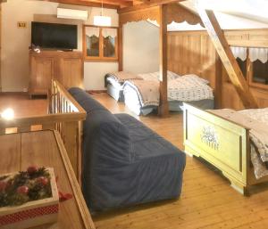 a room with three beds and a tv in it at Maison pittoresque à Sainte-Croix-aux-Mines, vue sur la montagne in Sainte-Croix-aux-Mines