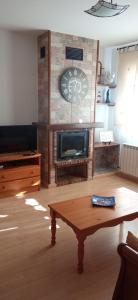 a living room with a fireplace and a coffee table at La Pérgola Internet Fibra Garage Calefacción TV in Bronchales +28 photos