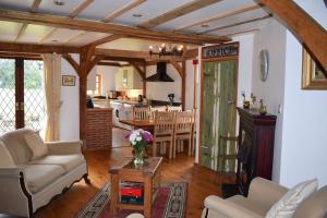 a living room with a couch and a table at The Olde Dairy renovated barn in Buckinghamshire