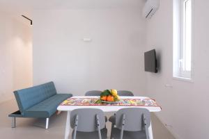 a dining room with a table and a blue chair at Temples and Sea view Apartment in Agrigento