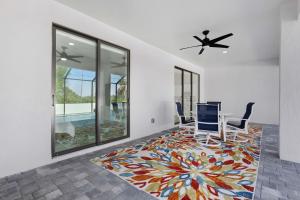 a dining room with a table and chairs on a colorful carpet at Hidden Gem, Heated Pool & Spa - Enchanted El Dorado Retreat - Roelens in Bonita Springs +42 photos