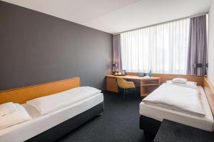 Postel nebo postele na pokoji v ubytování Best Western Hotel Kaiserslautern