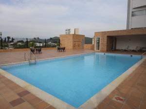 a large blue swimming pool in a building at Apartamento amoblado en Cucuta in Los Patios