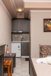 a kitchen with a refrigerator and a table in a room at Katerina Rooms & Apartments in Skala Potamias +26 photos