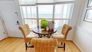 a dining room with a table and chairs and a window at Beautiful Sunrise in Folly Beach