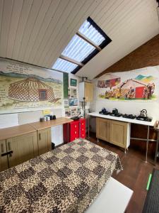 a room with a kitchen with a table and a window at Hemsford yurt camp - Devon Yurts in Totnes