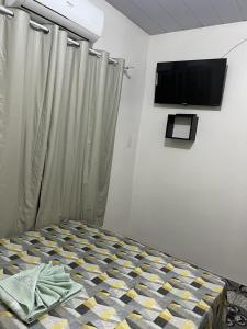 TV a/nebo společenská místnost v ubytování Pousada Irmãos Perrone