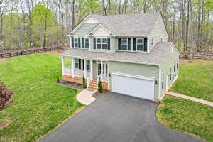 a house with a white garage at Lake House with Hot Tub and Fire Pit in Bumpass