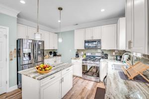a kitchen with white cabinets and a bowl of fruit on the counter at Lake House with Hot Tub and Fire Pit in Bumpass