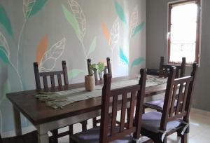a dining room with a wooden table and chairs at Las Bahuinias in San Fernando del Valle de Catamarca