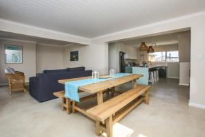 a living room with a table and a couch at Casa Azul Downstairs Apartment in Struisbaai