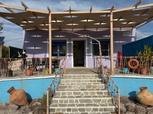 a house with a staircase leading up to a house at AegeanHeaven in Skala Eresou