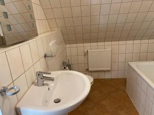 a bathroom with a sink and a toilet at Pension zum Zenshaus kleine Auszeit in Lychen