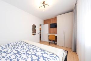 a white bedroom with a bed and a desk at Grand Chalet 10 Poiana Brașov in Poiana Brasov +10 photos
