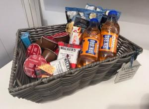 a basket filled with food and drinks on a table at Glenbervie - Beautifully refurbished, self-contained apartment in Fife