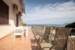 a balcony with chairs and a table and the ocean at Da Jaco in Castellammare del Golfo