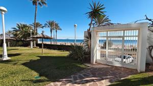 a gate at the beach with the ocean in the background at Playa y montaña. 1ª linea. Piscina. Parking . A/C in El Campello