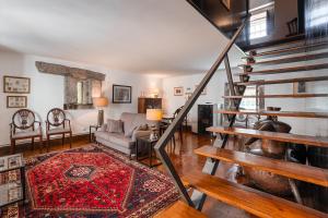 a living room with a staircase and a couch at Casa do Lagar in Cabeceiras de Basto