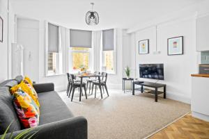 a living room with a couch and a table at KGV Stays - Central Family Apartment, Sleeps 6, 7 Minute Walk to Beach, PET friendly in Bournemouth