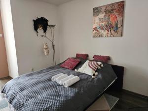 a bed with three pillows on it in a bedroom at Stone Bridge Studio in Iaşi