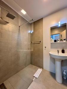 a bathroom with a sink and a shower at Apartament Alma in Sinaia +39 photos