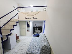 a room with a staircase with a blue and white tile floor at Victor's Room in Cetara