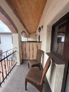 a balcony with two chairs and a wooden ceiling at Hotel Plzeňský Dvůr in Frýdek-Místek