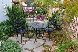 three chairs and a table in a garden at Exclusive Apt in Shaw in Washington, D.C.