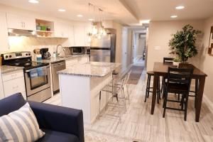 a kitchen with a counter and a table in a room at Exclusive Apt in Shaw in Washington, D.C.
