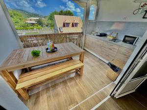 a tiny house with a table and a kitchen at Studio à 1 min de la plage ! in Sainte-Luce