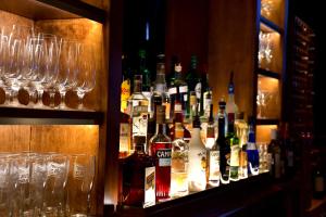 a bar with many bottles of alcohol and glasses at Tait House by Bower Boutique Hotels in Shediac +7 photos