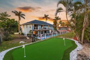 an aerial view of a house with a putting green at Casa Marco - Heated Pool, Game Room, Mini Golf in Marco Island