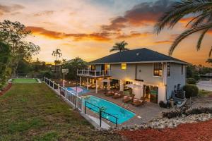 an aerial view of a house with a swimming pool at Casa Marco - Heated Pool, Game Room, Mini Golf in Marco Island