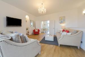 a living room with two couches and a tv at 10 Cove View in Ilfracombe