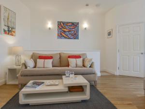 a living room with a couch and a table at 10 Cove View in Ilfracombe