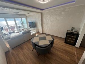 a living room with a couch and a table at Apartament with sea view in Nice +4 photos